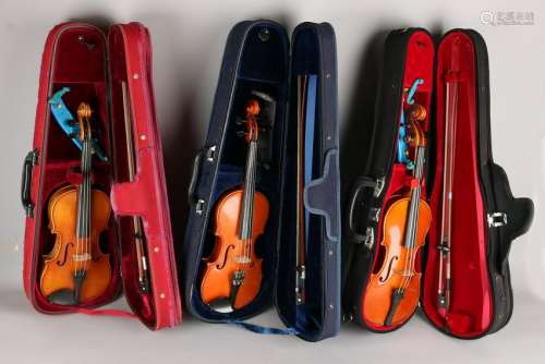 Three old children's practice violins + bags. Second