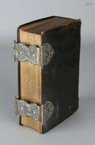 Bible with black leather cover with 2 silver locks with