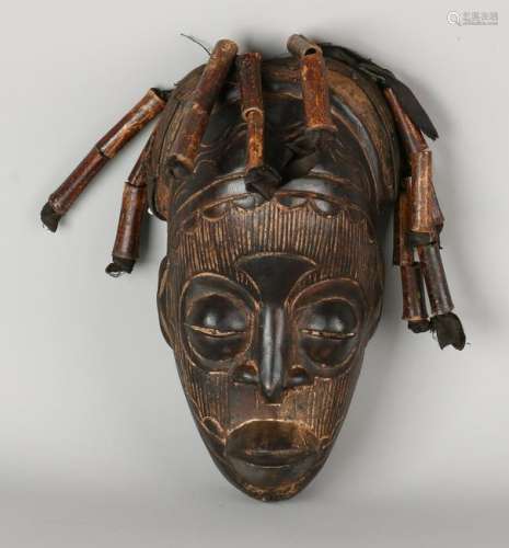 Old African mask with leather and bamboo hair.