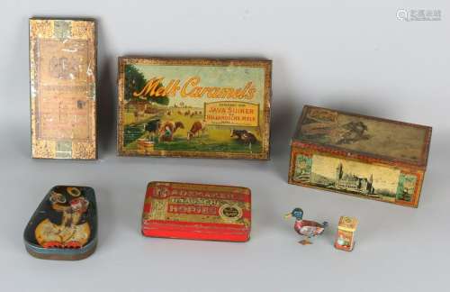 Seven antique cans. Among others: Verkade, Hulst,