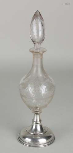 Crystal carafe with etched work, placed on a round