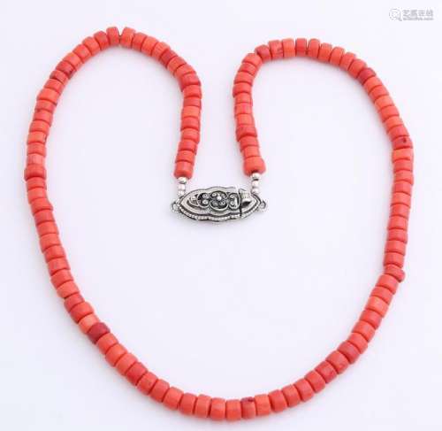 Red coral necklace with a red color, attached to a