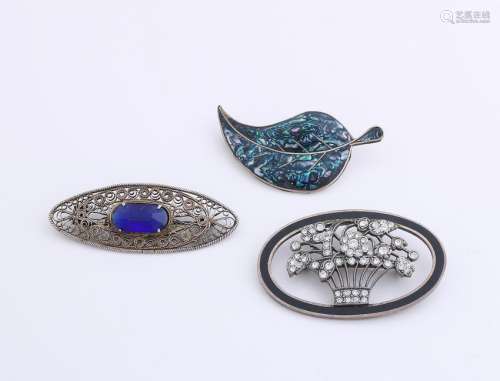 Three brooches, 2 oval silver models, one with blue