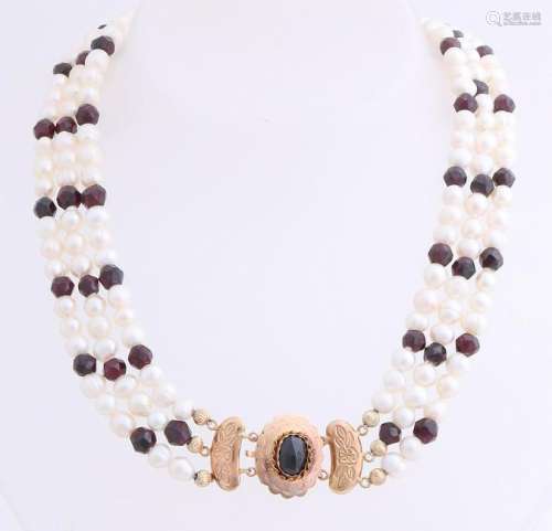 Necklace with garnet and pearls attached to a yellow