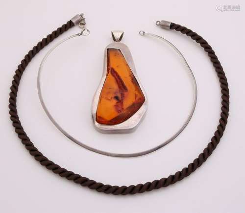 Silver necklace with a robust pendant with amber. also