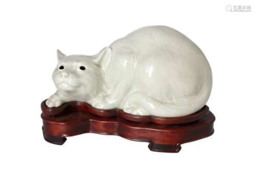 A celadon glazed porcelain sculpture of a cat, on wooden base. Unmarked. China, 20th century. L.