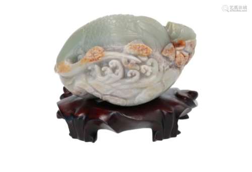 A jade and russet carved boulder, depicting a crane on lotus leaf, on wooden base. China, 20th