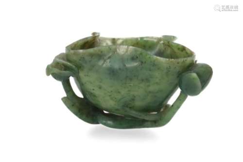 A carved jade libation cup in the shape of a lotus flower. China. L. 13,5 cm. H. 7 cm. Provenance: