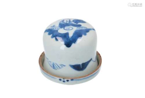 A blue and white porcelain tool for a dice game, decorated with a figure. Unmarked. With wax