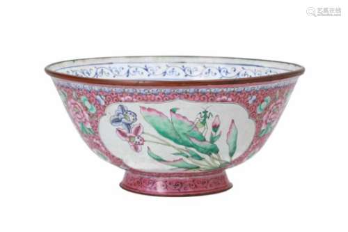 A polychrome enameled metal bowl, decorated with flowers and insects. The inside center with fish.