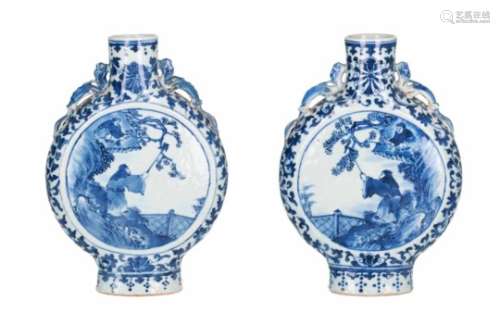 A pair of blue and white porcelain moon flasks, decorated with figures and flowers. The handles in