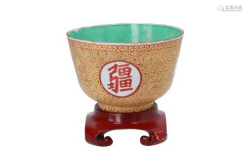 A polychrome sgraffiato porcelain bowl on wooden stand, decorated with characters. Marked with