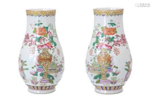 A pair of polychrome porcelain vases, decorated with flowers and animals. Marked with seal mark