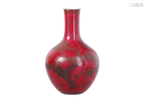 A red porcelain vase, decorated with a dragon chasing the pearl. Marked with seal mark Qianlong.