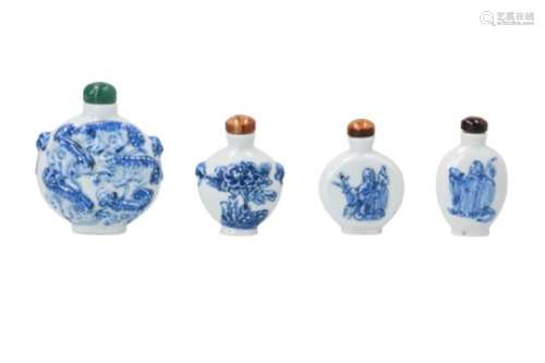 Lot of four blue and white porcelain snuff bottles, decorated in relief with figures, animals and