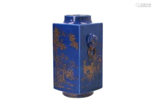 A blue glazed porcelain cong vase with two handles in the shape of elephant heads holding a ring,
