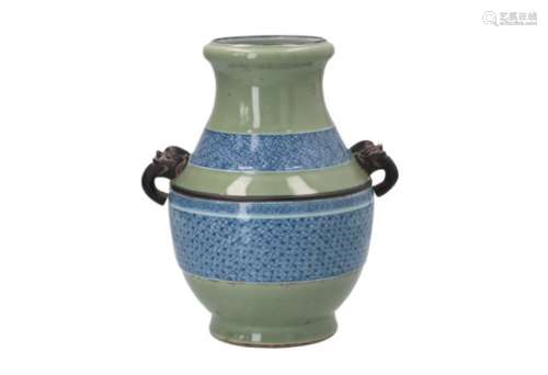 A celadon glazed porcelain vase with two handles in the shape of mythical animals and blue and white