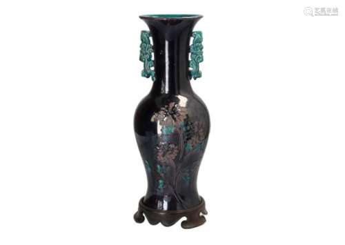 A turquoise and purple glazed porcelain vase on wooden base,with two handles and relief decor of