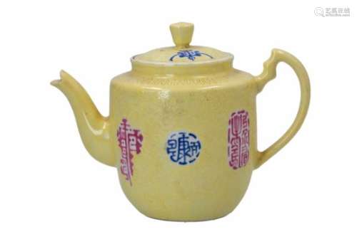 A famille jaune and sgraffiato porcelain teapot, decorated with characters. Marked with 4-