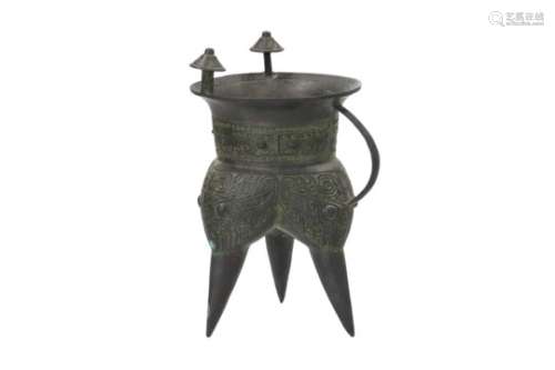 A bronze tripod jia with archaic relief decor. Unmarked. China, 20th century. H. 23 cm.