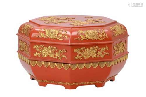 A hexagonal red lacquer biscuit box with gilded decor of a butterfly and flowers. Unmarked. China,