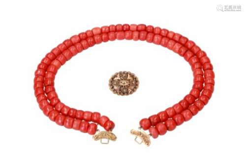 A two-strand red coral necklace with 18-kt gold clasp. Diam. approx. 9 - 10,9 mm. Tot. weight