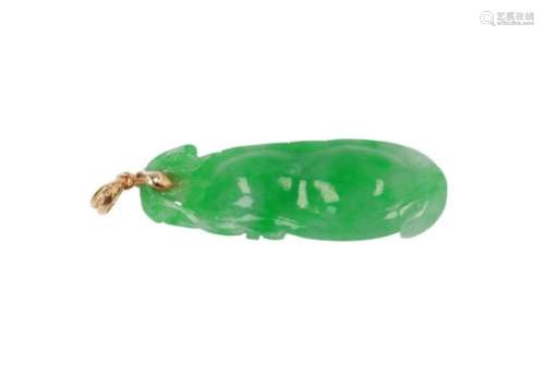 A fruit shaped jade pendant with golden mounting.