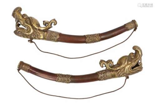A pair of red copper lamaistic temple trumpets with yellow copper mounting in the shape of animal