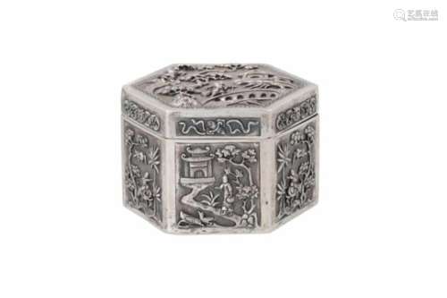 A hexagonal silver box, decorated in relief with figures, animals, flowers and pagodas in landscape.