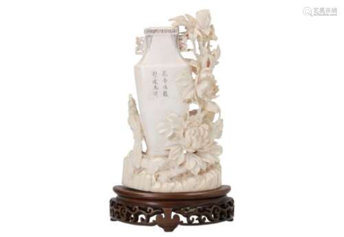 A carved ivory vase on wooden base, decorated with a bird, flowers and poems. Unmarked. China,