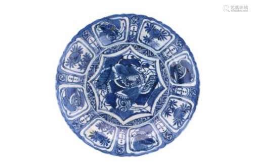 A blue and white 'kraak' porcelain dish, decorated with flowers, fruits and antiquities. Unmarked.