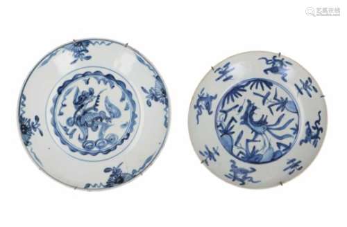 Lot of two blue and white porcelain chargers, decorated with birds and flowers. One charger