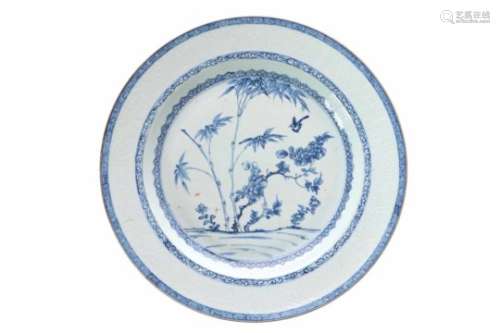 A blue and white porcelain deep charger, decorated with the three friends of winter. The rim with