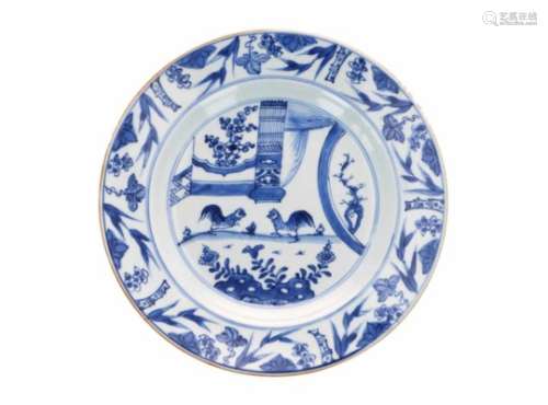 A blue and white porcelain charger, decorated with two roosters in a garden. Unmarked. China,