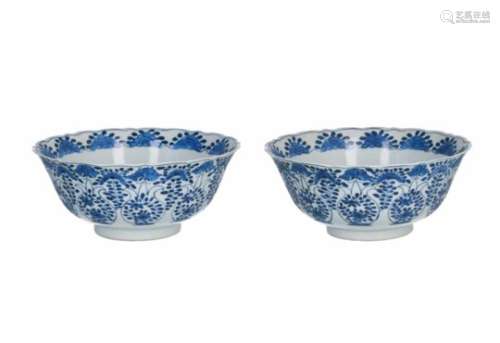 A pair of blue and white porcelain bowls, decorated with flowers and butterflies. Marked with 4-