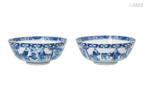 A pair of blue and white porcelain bowls, decorated with landscapes and scholars. Marked with 4-