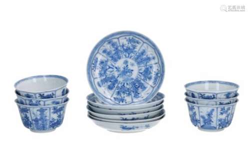 A set of six blue and white porcelain cups with saucers, decorated with flowers. Marked with 6-