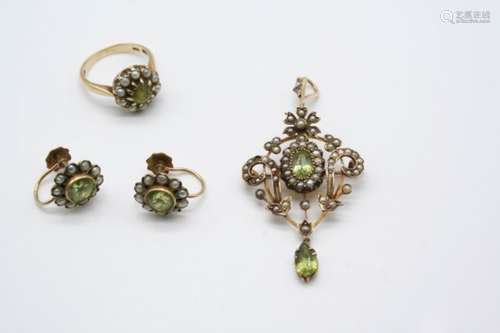 AN EDWARDIAN PERIDOT AND PEARL SET PENDANT the openwork foliate gold mount is set with an oval-