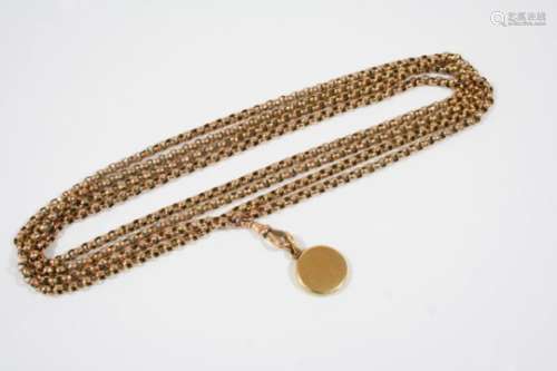 A VICTORIAN 9CT. GOLD LONG GUARD CHAIN formed with circular hammered links, suspending a circular