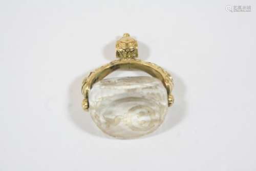 A CRYSTAL THREE SIDED SPINNING FOB SEAL engraved on two sides with a coat of arms, in an ornate