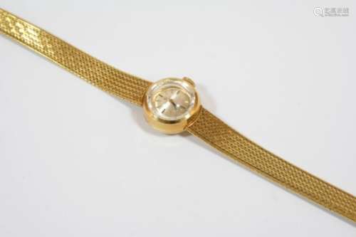 A LADY'S 18CT. GOLD WRISTWATCH BY OMEGA the signed circular dial with baton numerals, in an integral