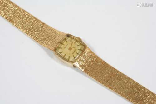 A LADY'S 9CT. GOLD WRISTWATCH the cushion-shaped dial signed Geneve and with baton numerals,