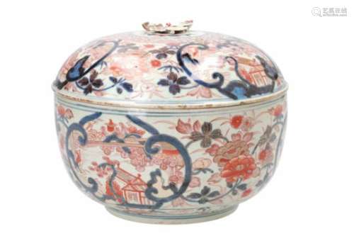 A pair of Imari porcelain lidded bowls, decorated with flowers and pagodas. The grips in the shape