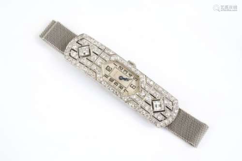 AN ART DECO LADY'S DIAMOND COCKTAIL WRISTWATCH the arched shaped dial with Arabic numerals, the