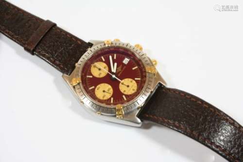 A STAINLESS STEEL AUTOMATIC CHRONOGRAPH WRISTWATCH BY BREITLING the signed dial with baton numerals,