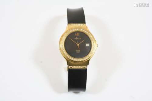 AN 18CT. GOLD WRISTWATCH BY HUBLOT the signed black dial with date aperture, with circular-cut