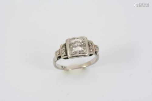 A DIAMOND SOLITAIRE RING the circular-cut diamond is set with three single-cut diamonds to each