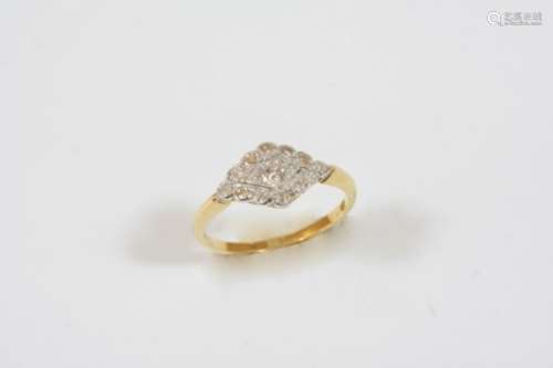 A DIAMOND CLUSTER RING of marquise-shape, the circular-cut diamond is set within a surround of