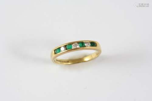 AN EMERALD AND DIAMOND HALF HOOP RING set alternately with circular-cut emeralds and diamonds in