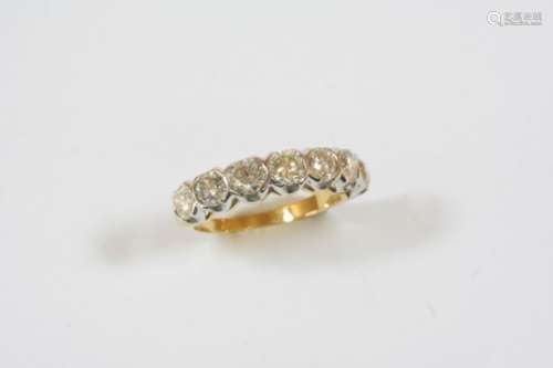 A DIAMOND HALF HOOP RING set with seven circular-cut diamonds, in 18ct. yellow gold. Size N.